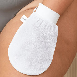 Wildpier white exfoliating glove on a thigh